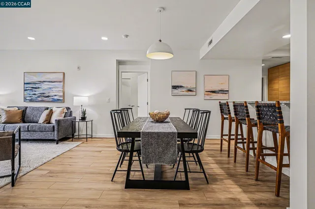 a view of a a dining room with furniture window and wooden floor