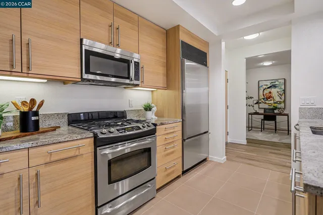 a kitchen with stainless steel appliances granite countertop a stove and a refrigerator