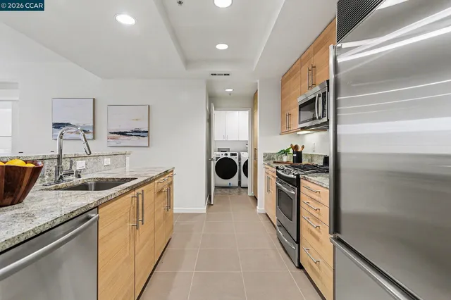 a kitchen with stainless steel appliances granite countertop a sink and a stove