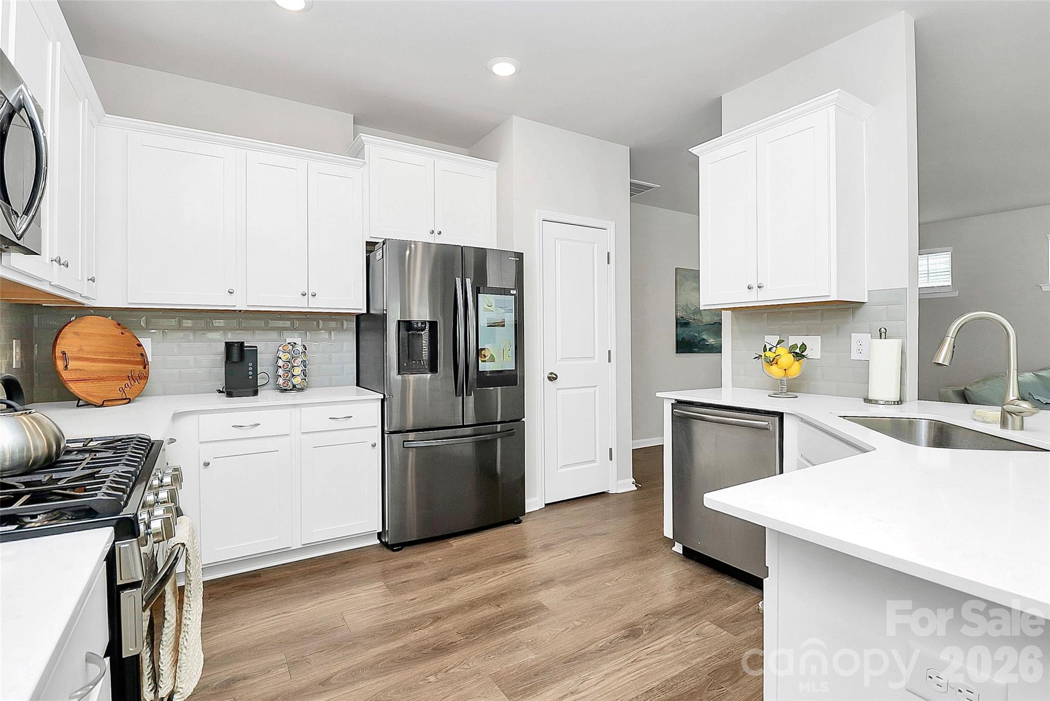 5766 Soft Shell Drive Lancaster, SC 29720 - Photo 11 of 33 a kitchen with stainless steel appliances a refrigerator stove microwave and sink