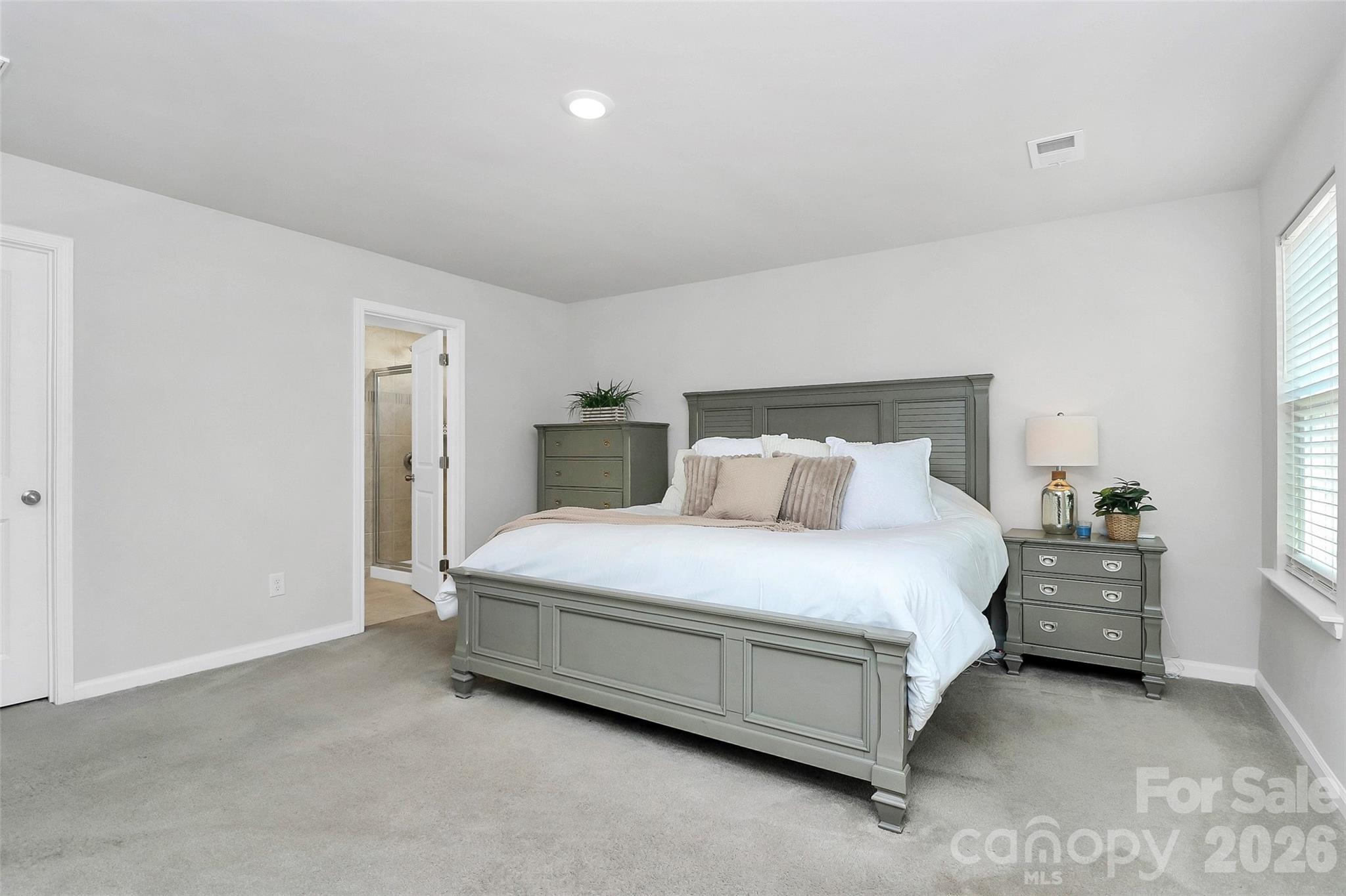 5766 Soft Shell Drive Lancaster, SC 29720 - Photo 14 of 33 a spacious bedroom with a bed and a cabinets