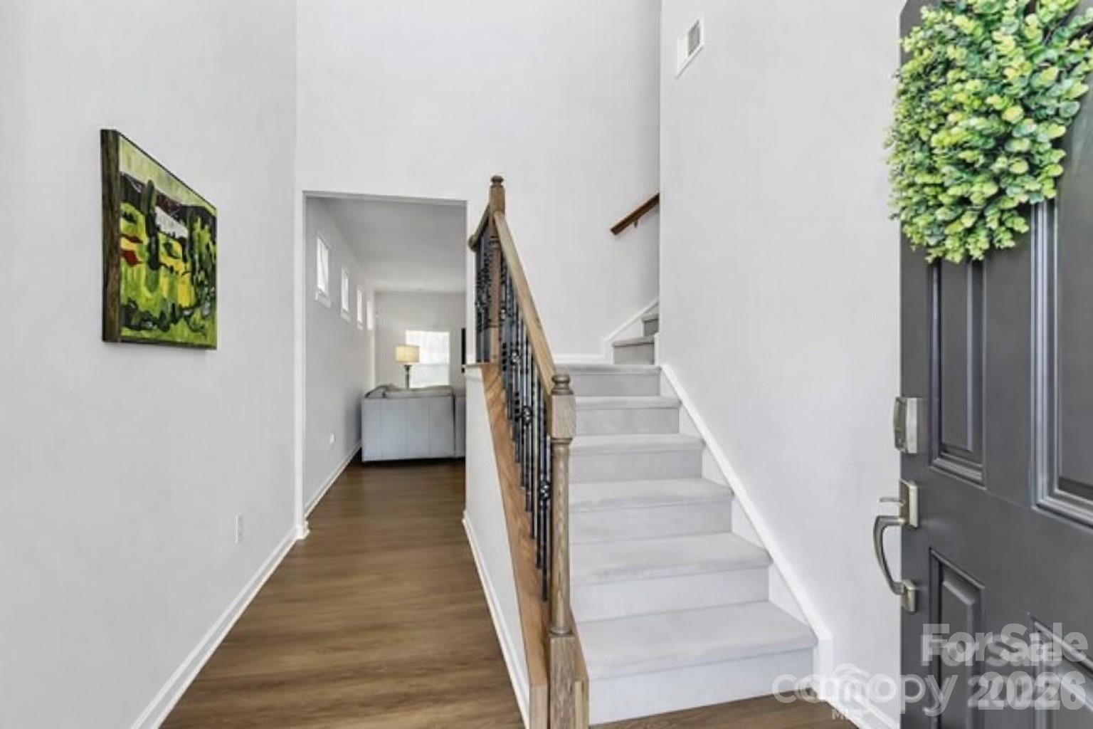 5766 Soft Shell Drive Lancaster, SC 29720 - Photo 3 of 33 a view of a hallway with wooden floor and stairs