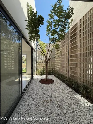 a vase of flowers sitting on a floor in front of a door