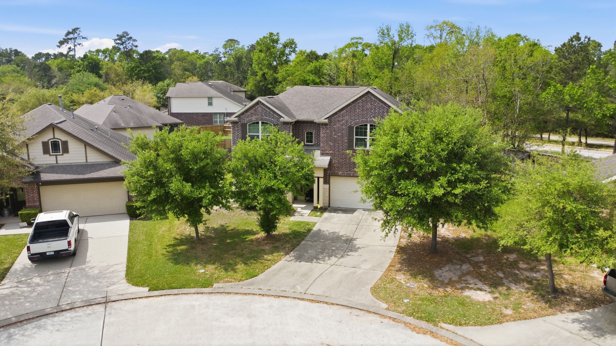 7 Maple Mill Court Conroe, TX 77301 - Photo 20 of 21 a aerial view of a house with a yard table and chairs