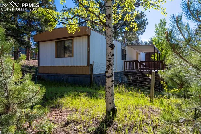 a backyard of a house with yard and outdoor seating