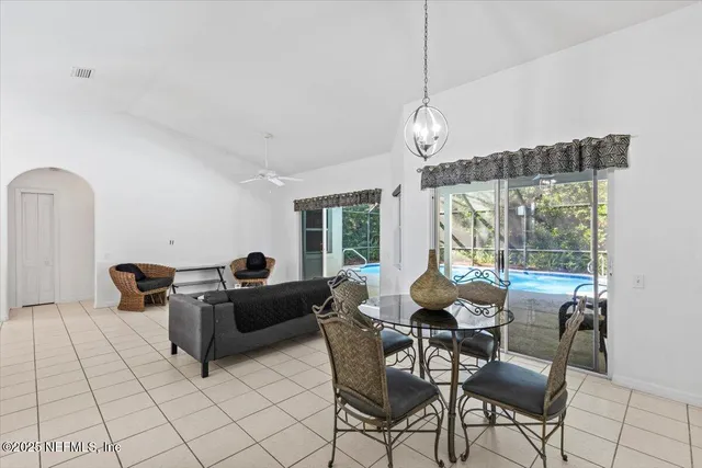 a living room with furniture chandelier and a large window