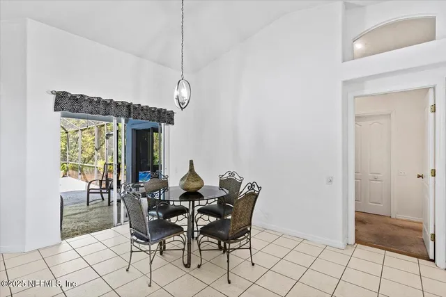 a dining room with furniture and a chandelier