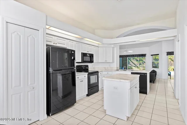 a kitchen with stainless steel appliances a refrigerator sink and microwave