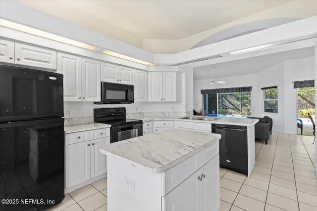 a kitchen with a stove a sink and a refrigerator