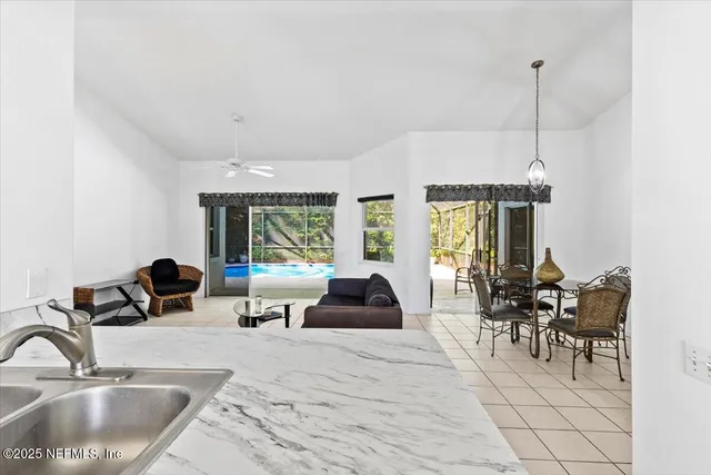 a living room with furniture a window and a chandelier