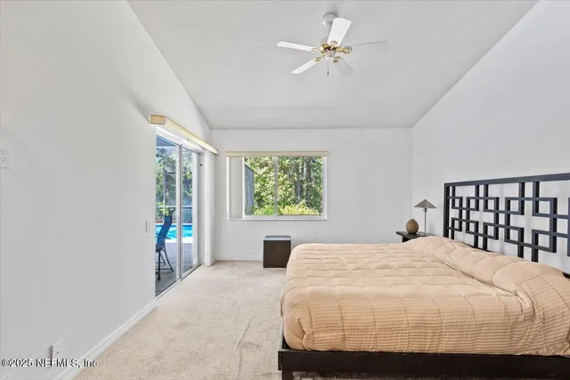 a bedroom with a large bed and a window