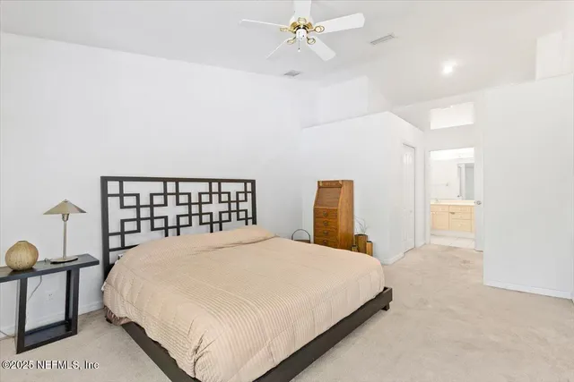 a large bed sitting in a bedroom and table