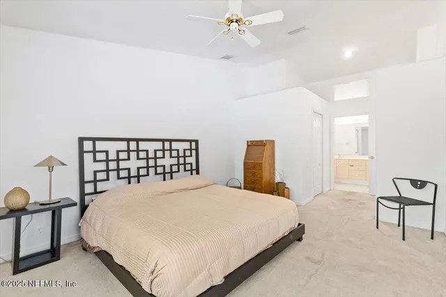 a bedroom with a bed and painting on the wall