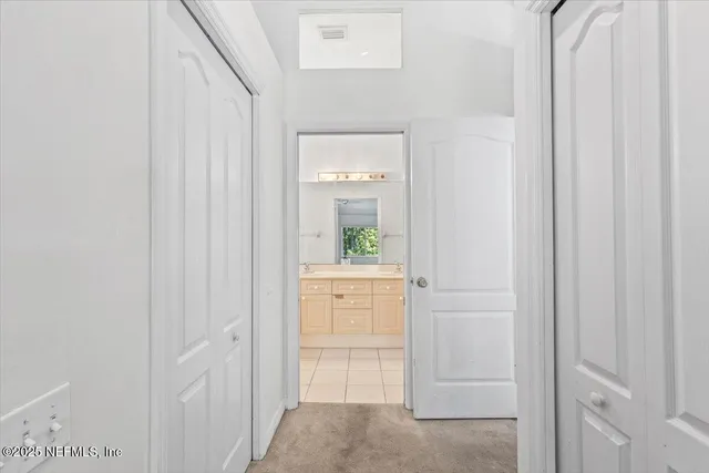 a bathroom with a vanity mirror and window