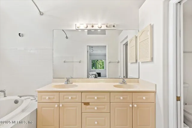 a bathroom with a sink double vanity and a mirror