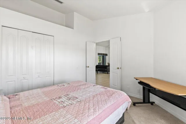 a bedroom with a bed and a desk