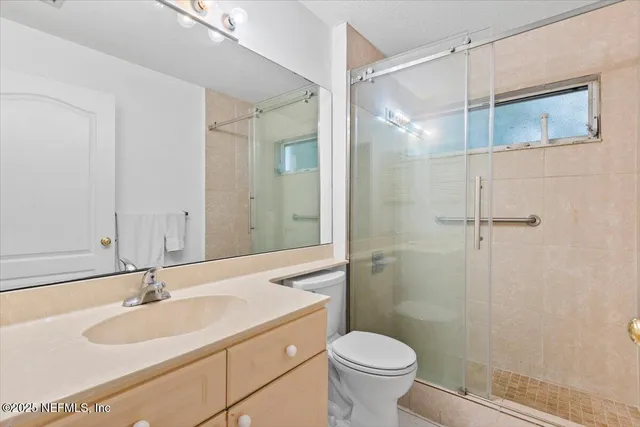 a bathroom with a sink toilet and shower