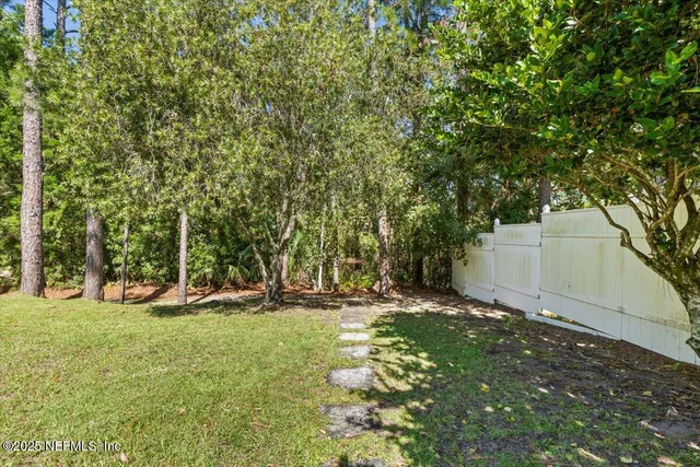 a backyard of a house with table and chairs