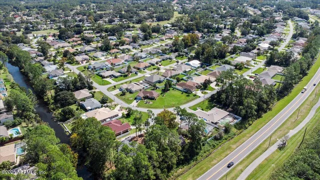 an aerial view of a residential houses with street