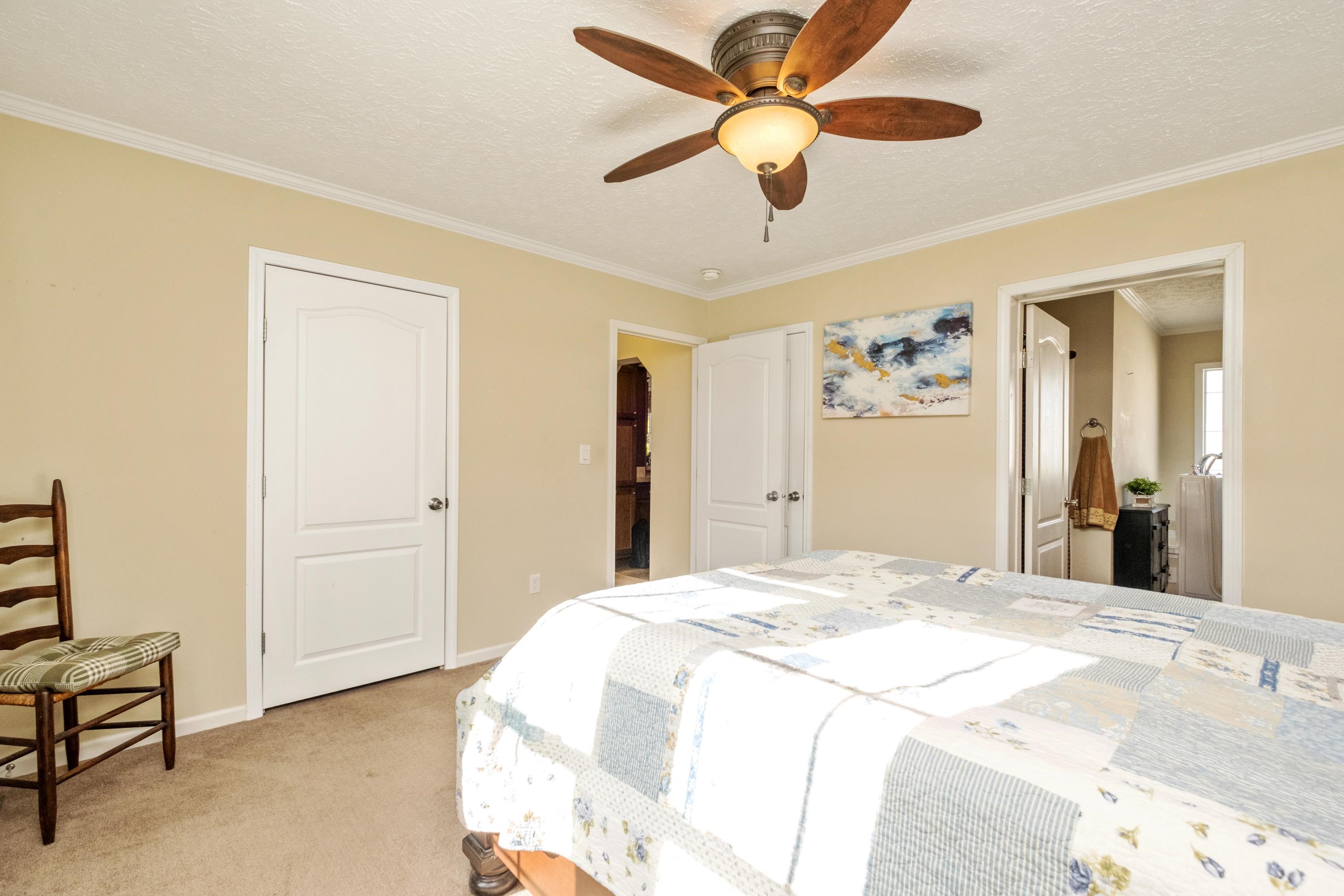 1715 3rd Street Waynesboro, VA 22980 - Photo 21 of 33 a bedroom with a bed and a chandelier