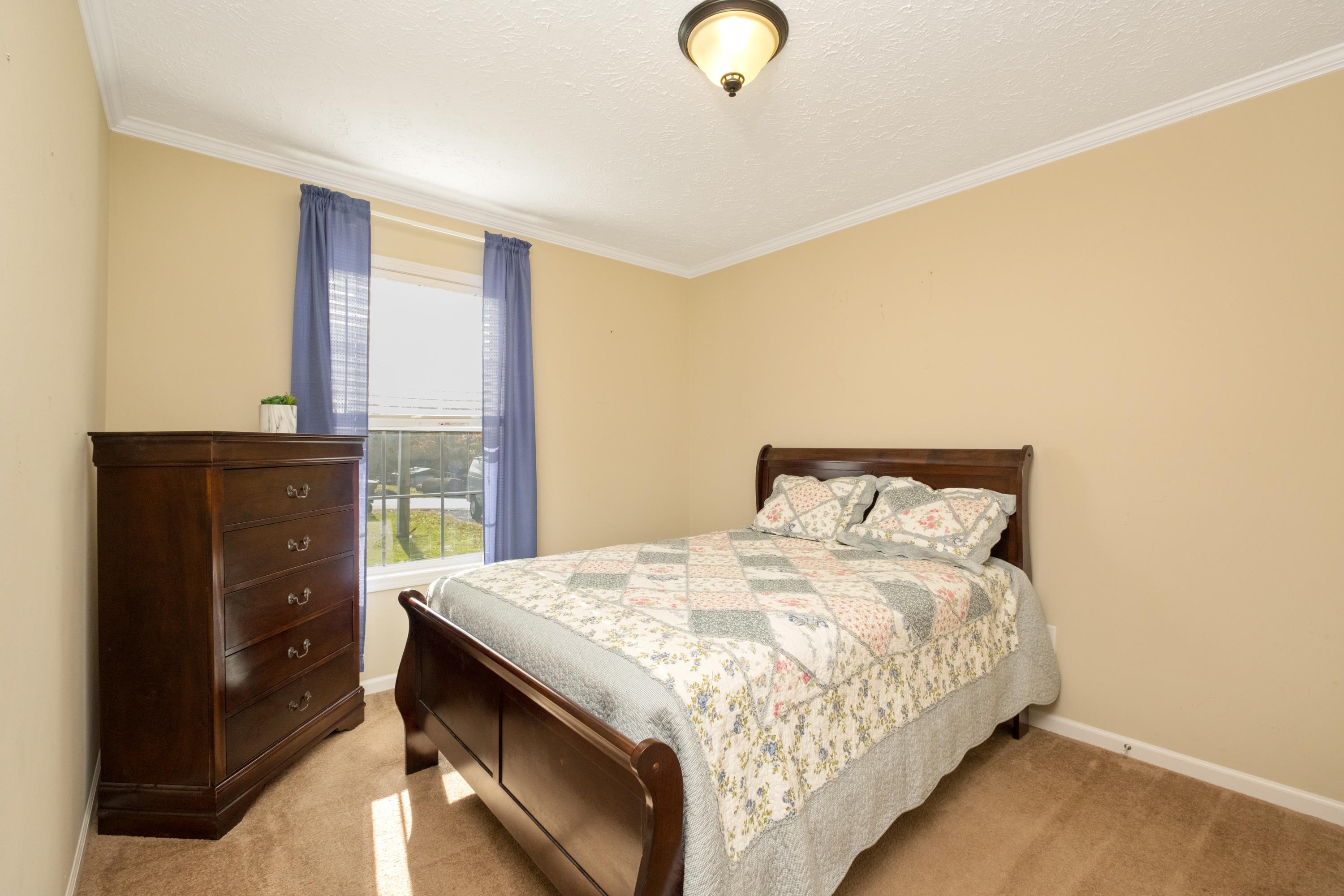 1715 3rd Street Waynesboro, VA 22980 - Photo 24 of 33 a bedroom with a bed and dresser