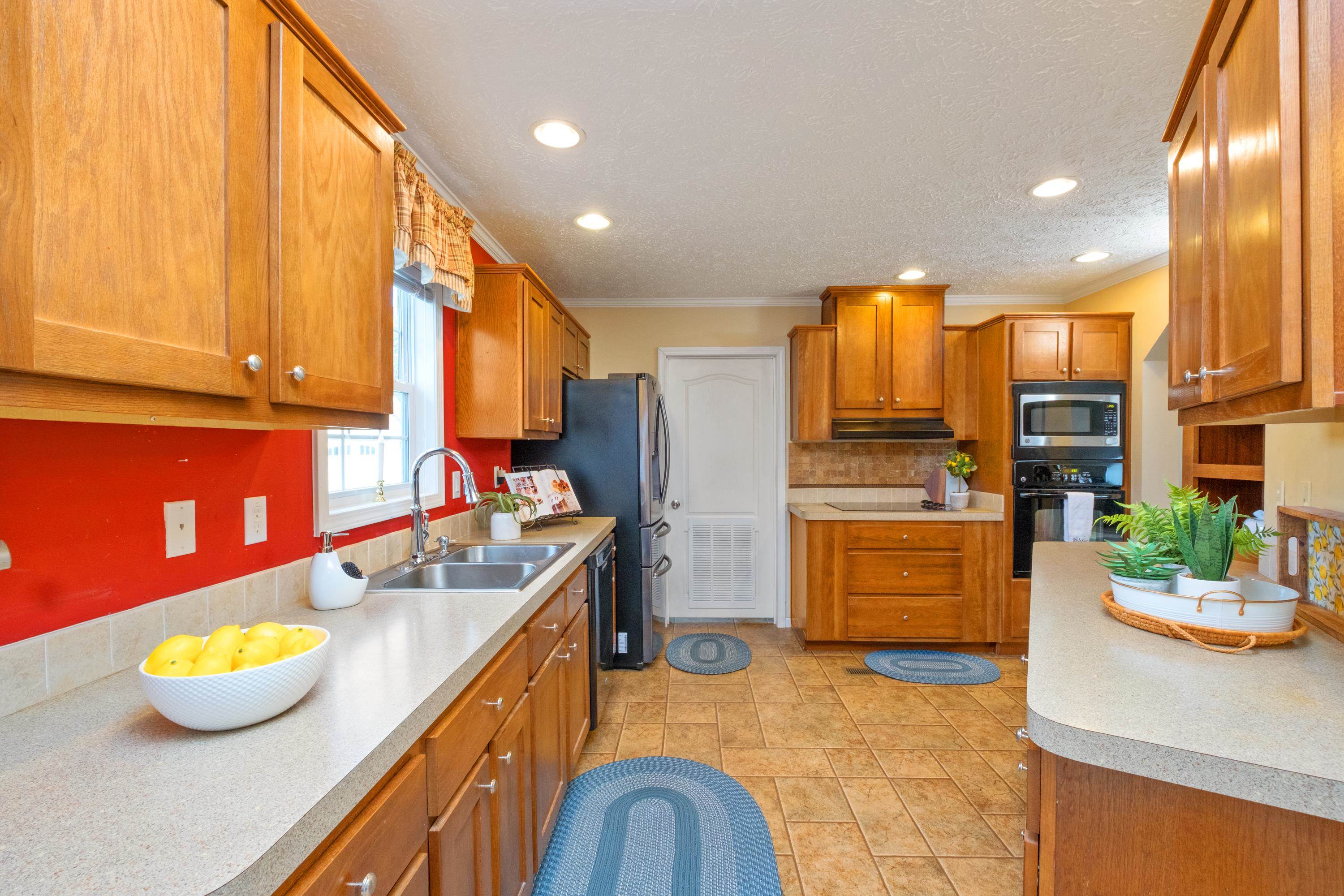 1715 3rd Street Waynesboro, VA 22980 - Photo 4 of 33 a kitchen with stainless steel appliances granite countertop a sink a stove and a refrigerator