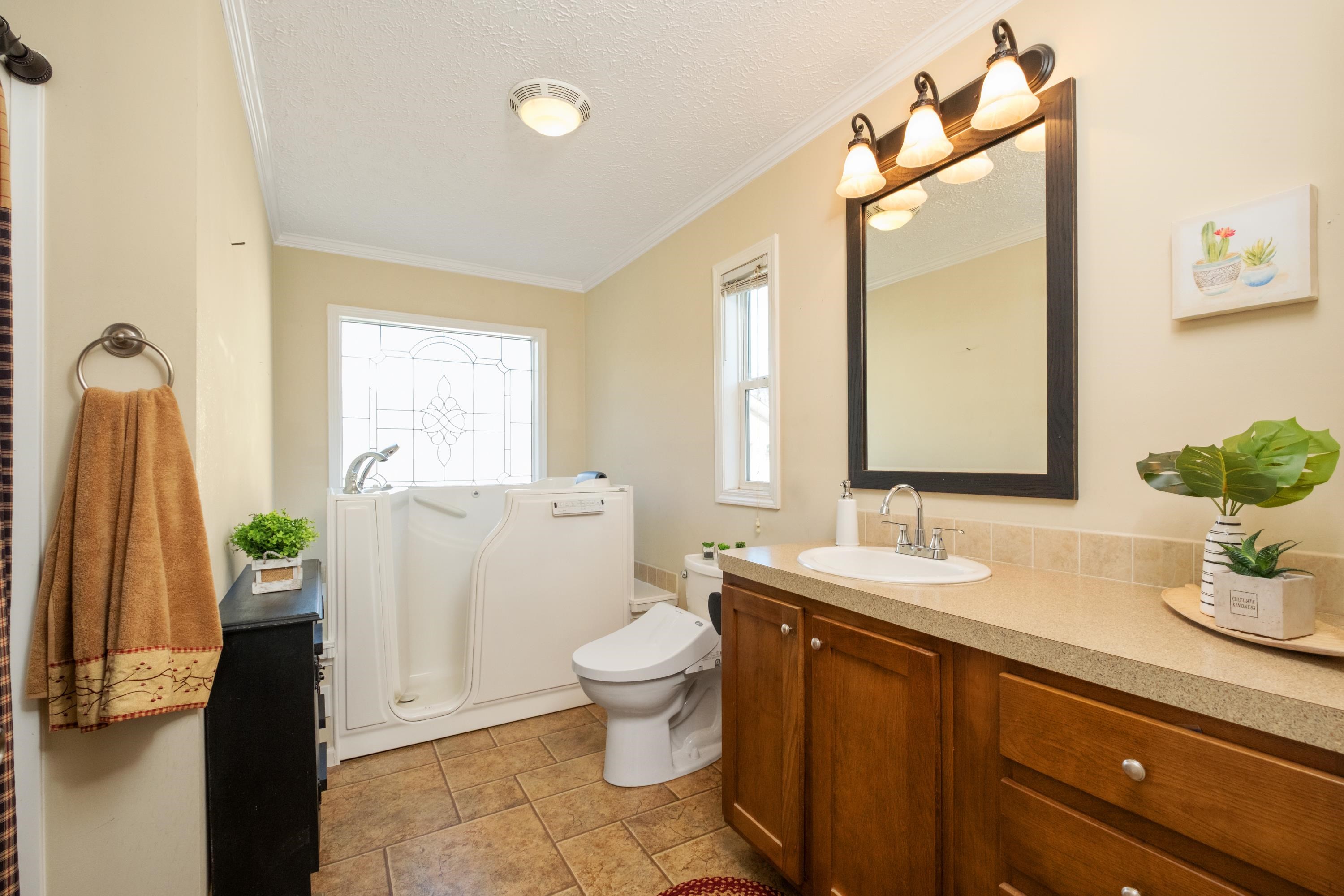 1715 3rd Street Waynesboro, VA 22980 - Photo 8 of 33 a bathroom with a granite countertop sink toilet and mirror
