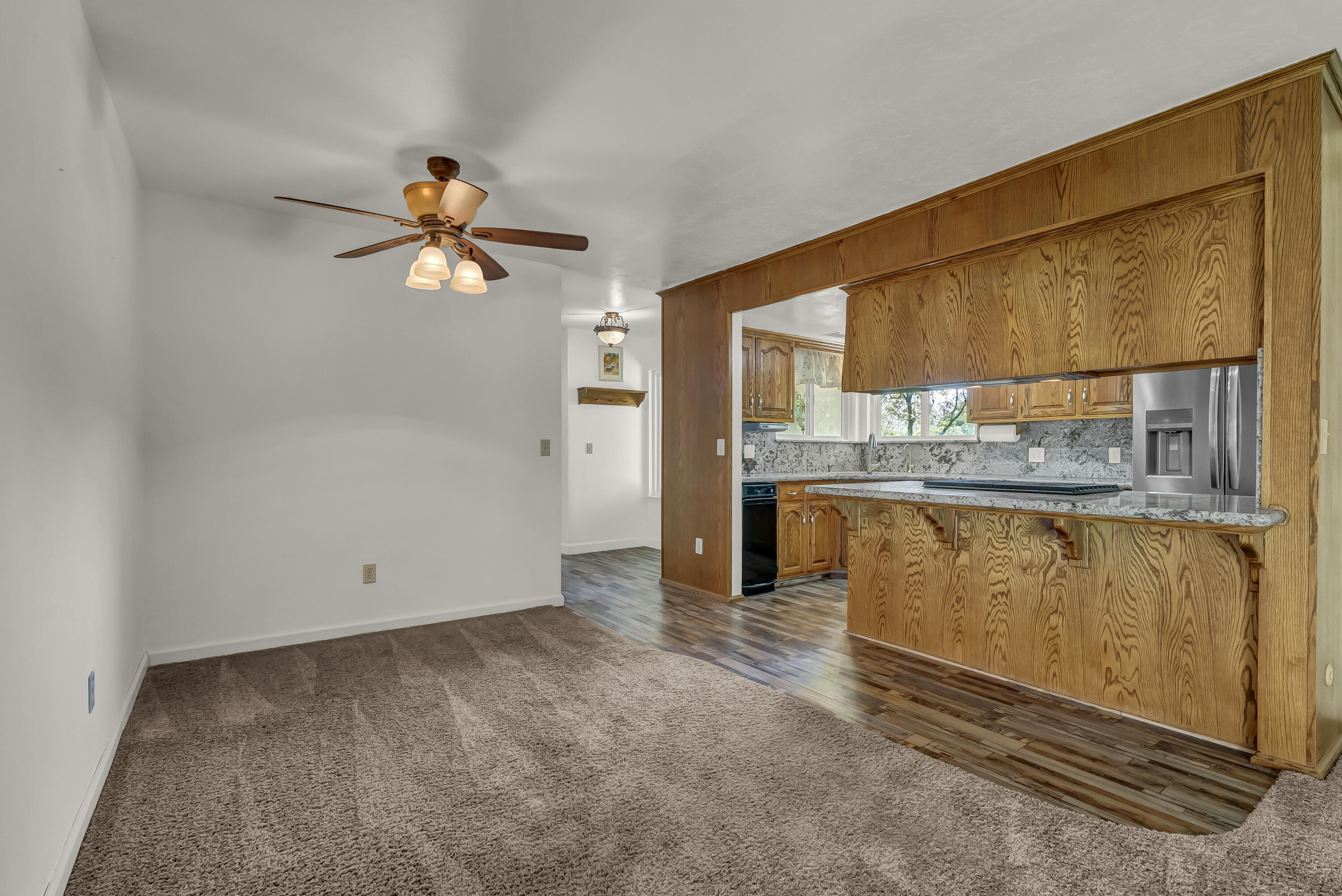 18002 320th Road Springville, CA 93265 - Photo 22 of 56 an empty room with a kitchen view of a house