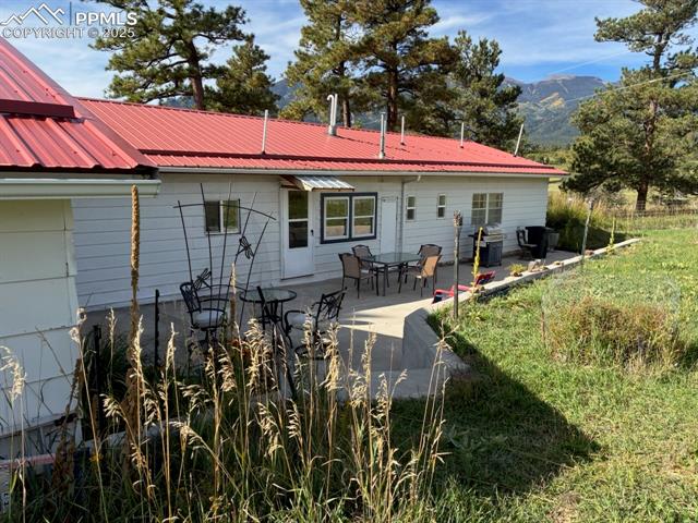 8201 Old San Isabel Road Rye, CO 81069 - Photo 28 of 30 Rear view of house with a patio area, a metal roof, a mountain view, and outdoor dining area