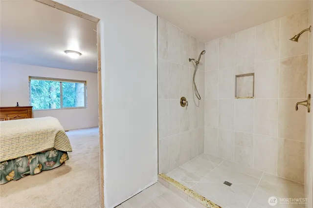 a bath tub sitting in a bathroom next to a window