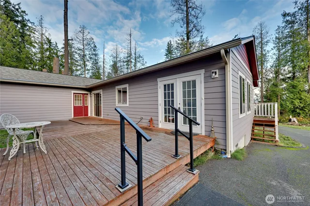 a backyard of a house with table and chairs