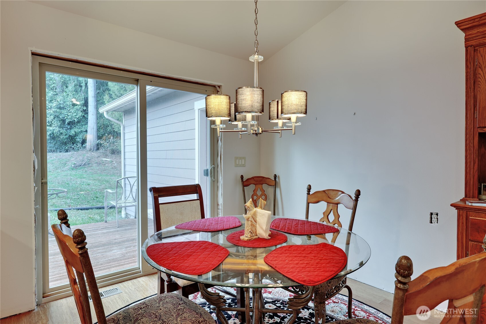 20919 President Point Road Northeast Kingston, WA 98346 - Photo 9 of 24 a view of a dining room with furniture a chandelier and wooden floor
