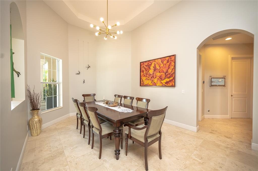 6359 Bellamalfi Street Boca Raton, FL 33496 - Photo 14 of 86 a view of a dining room with furniture and a chandelier