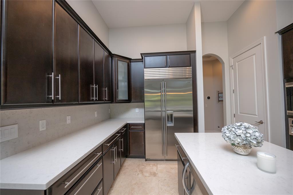 6359 Bellamalfi Street Boca Raton, FL 33496 - Photo 19 of 86 a kitchen with stainless steel appliances kitchen island granite countertop a refrigerator a stove and a sink