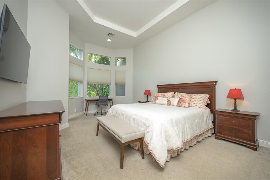 6359 Bellamalfi Street Boca Raton, FL 33496 - Photo 28 of 86 a bedroom with a bed and a flat tv screen on dresser