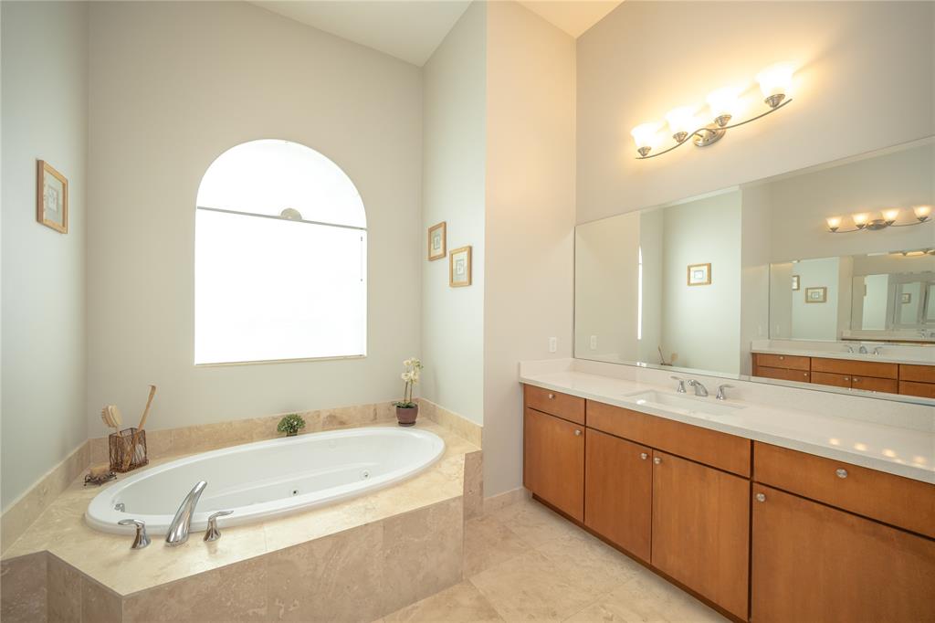 6359 Bellamalfi Street Boca Raton, FL 33496 - Photo 34 of 86 a bathroom with a granite countertop sink mirror and a bathtub