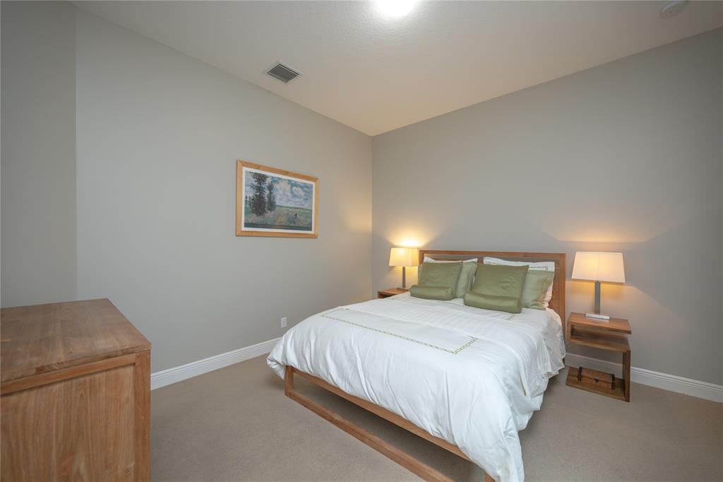 6359 Bellamalfi Street Boca Raton, FL 33496 - Photo 40 of 86 a bedroom with a bed and a night stand