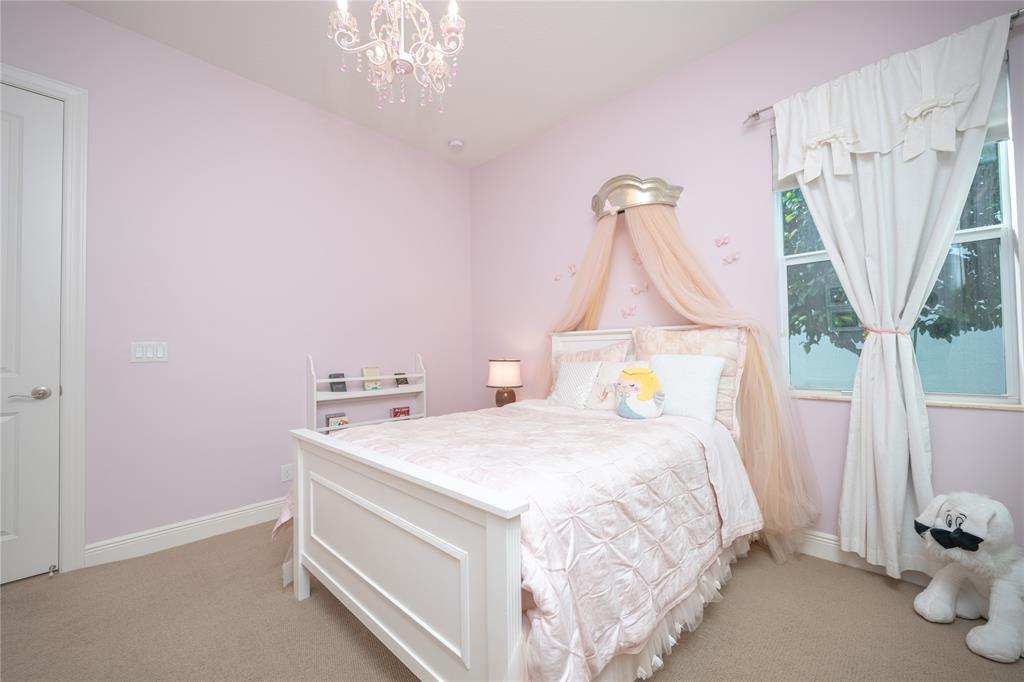 6359 Bellamalfi Street Boca Raton, FL 33496 - Photo 46 of 86 a bedroom with a bed and a table