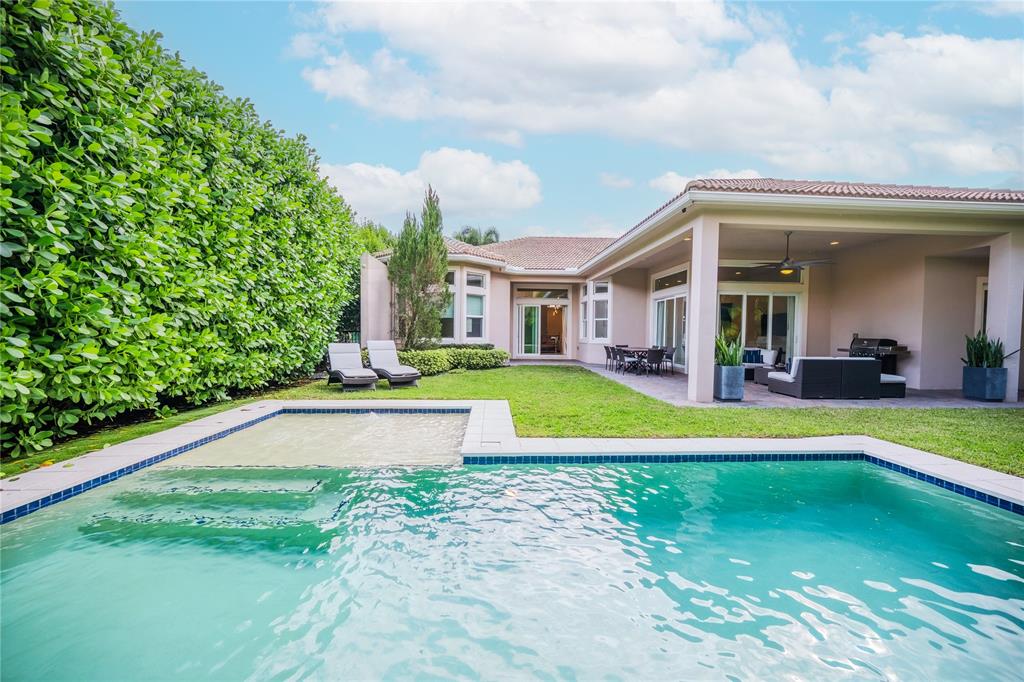 6359 Bellamalfi Street Boca Raton, FL 33496 - Photo 60 of 86 a view of pool with lawn chairs and large trees