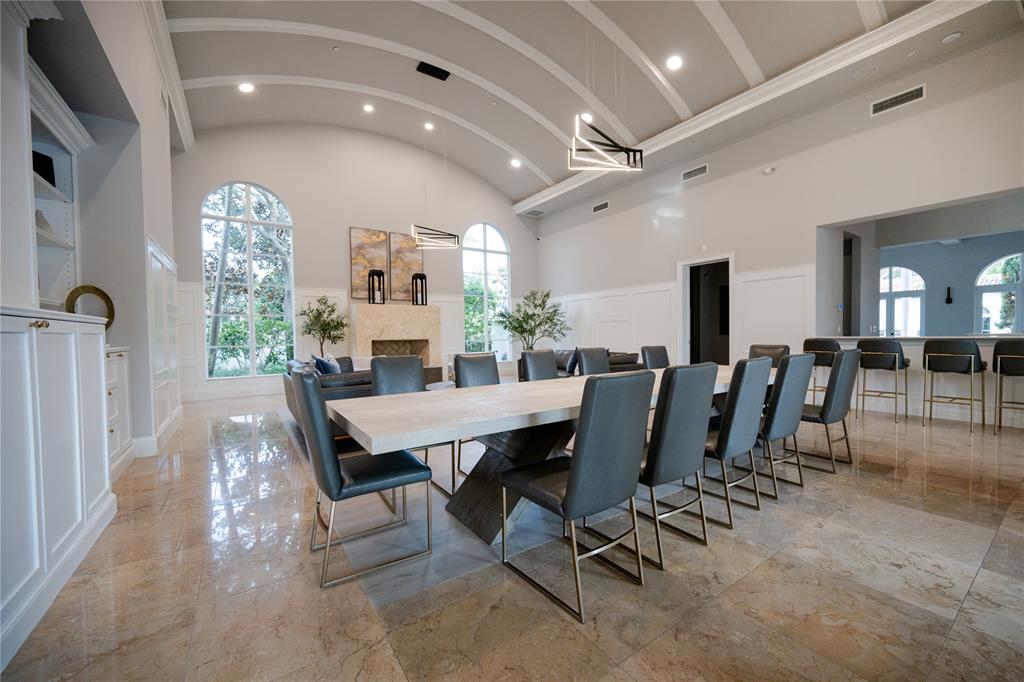 6359 Bellamalfi Street Boca Raton, FL 33496 - Photo 77 of 86 a dining room with furniture a rug and a chandelier