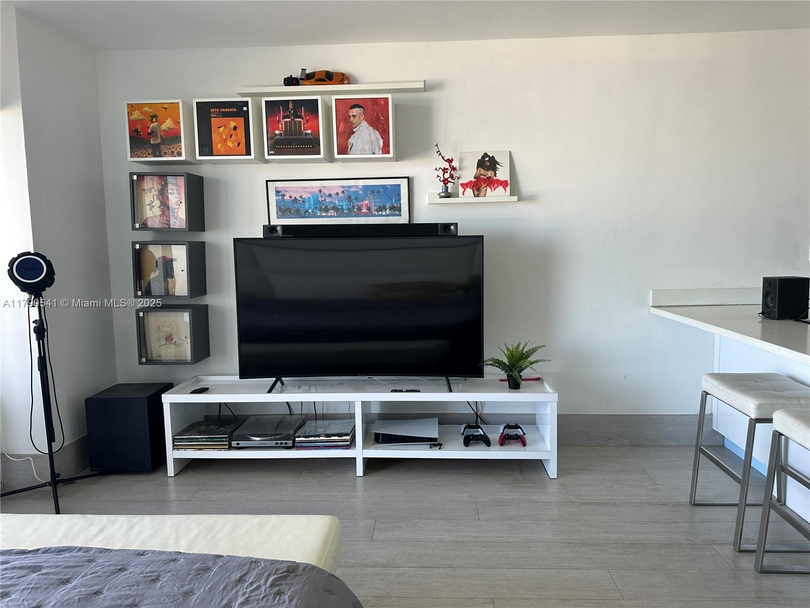 555 Northeast 15th Street, Unit 508 Miami, FL 33132 - Photo 6 of 25 a living room with furniture and a flat screen tv