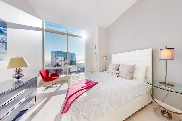 a bedroom with a bed and lamp