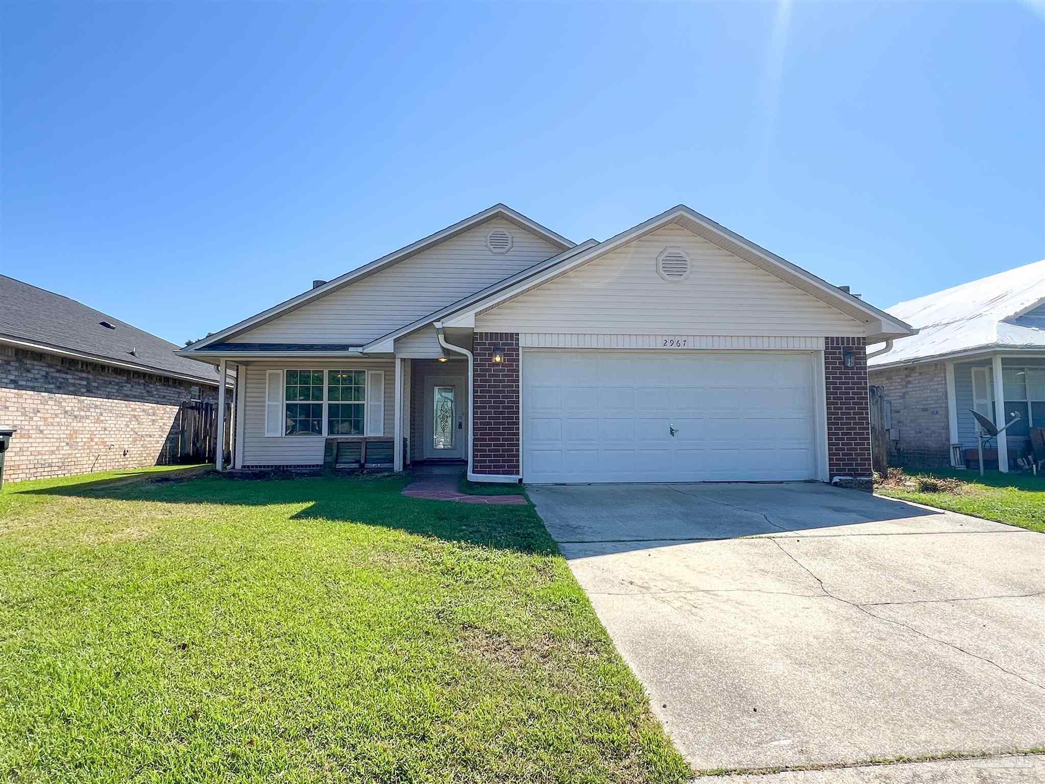 2967 Creole Way Pensacola, FL 32526 - Photo 1 of 30 a front view of a house with a yard and garage