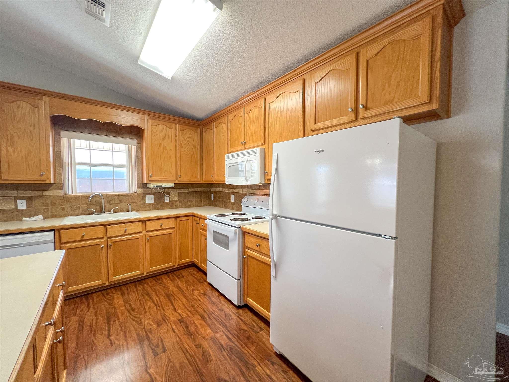 2967 Creole Way Pensacola, FL 32526 - Photo 11 of 30 a white refrigerator freezer sitting inside of a kitchen