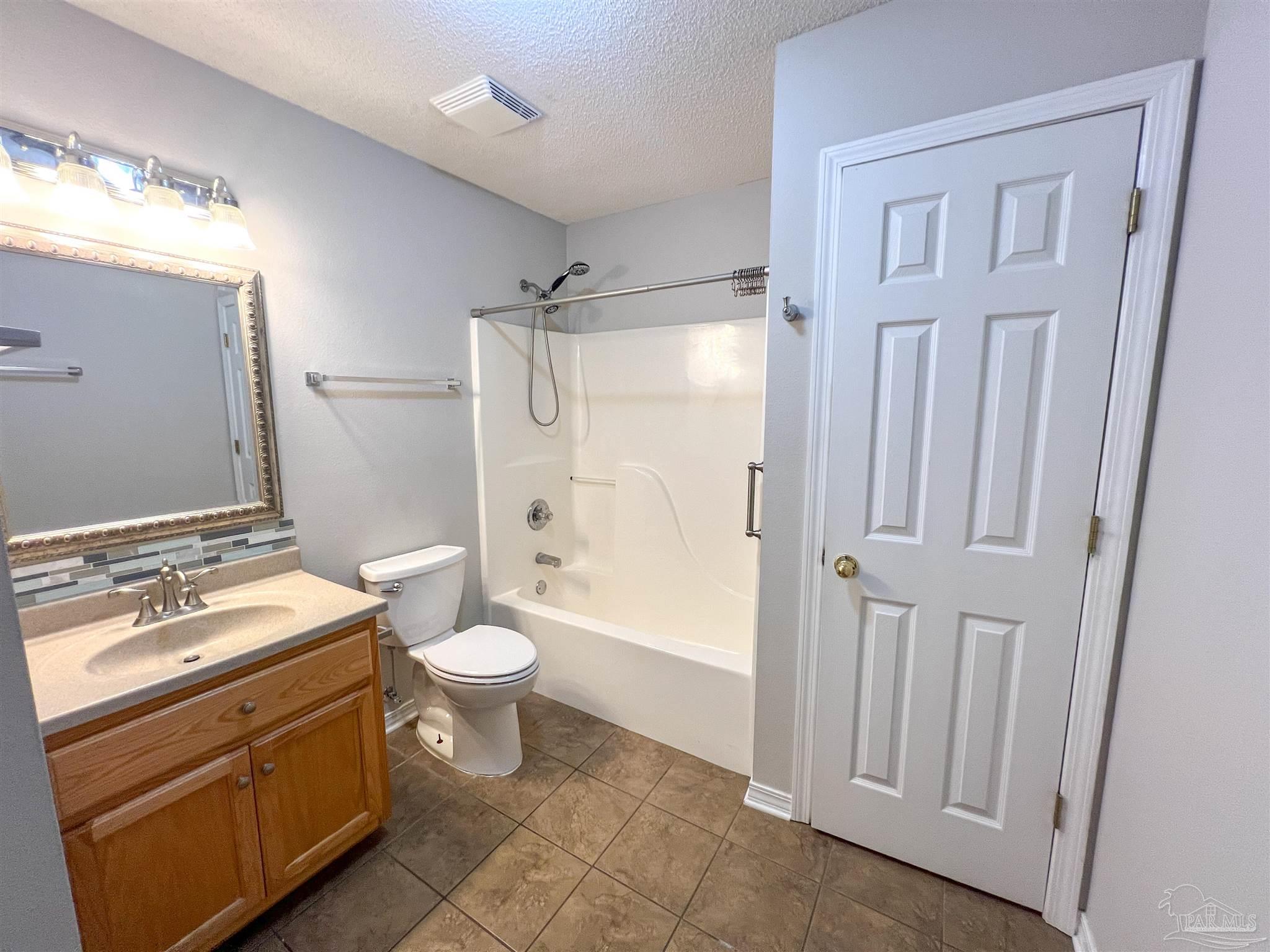 2967 Creole Way Pensacola, FL 32526 - Photo 26 of 30 a bathroom with a granite countertop sink toilet and shower