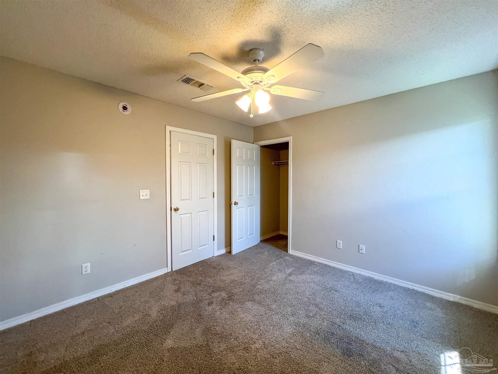 2967 Creole Way Pensacola, FL 32526 - Photo 28 of 30 a view of an empty room and a ceiling fan