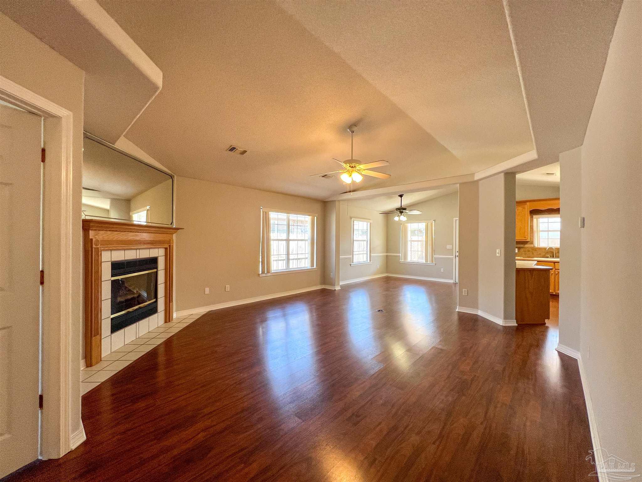 2967 Creole Way Pensacola, FL 32526 - Photo 3 of 30 a view of an empty room with window and wooden floor