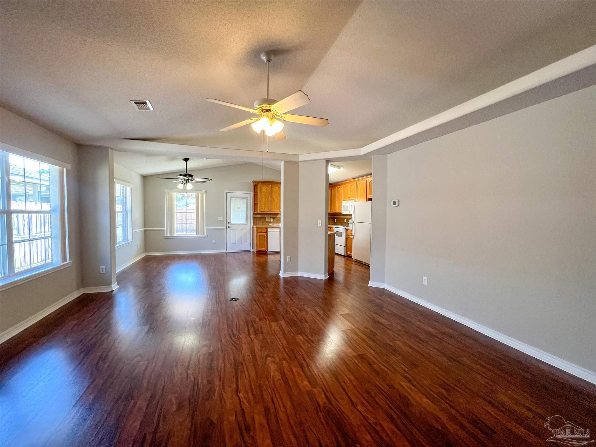 2967 Creole Way Pensacola, FL 32526 - Photo 6 of 30 a view of an empty room with wooden floor and a window