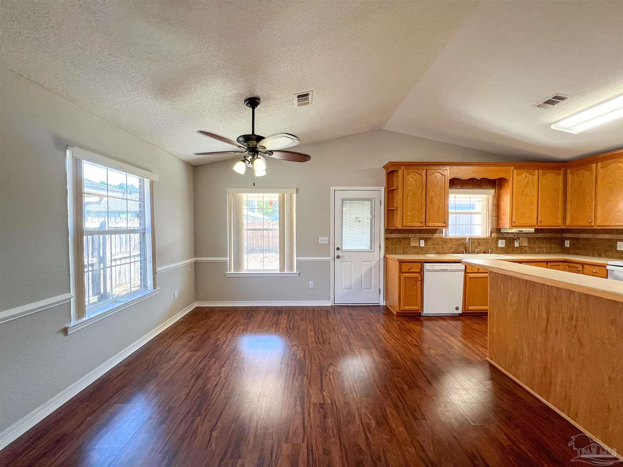 2967 Creole Way Pensacola, FL 32526 - Photo 7 of 30 a kitchen with a hard wood floor window and appliances