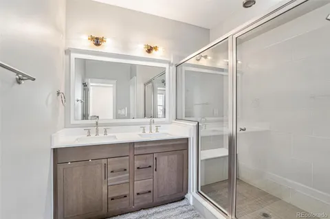 a bathroom with a double vanity sink and mirror